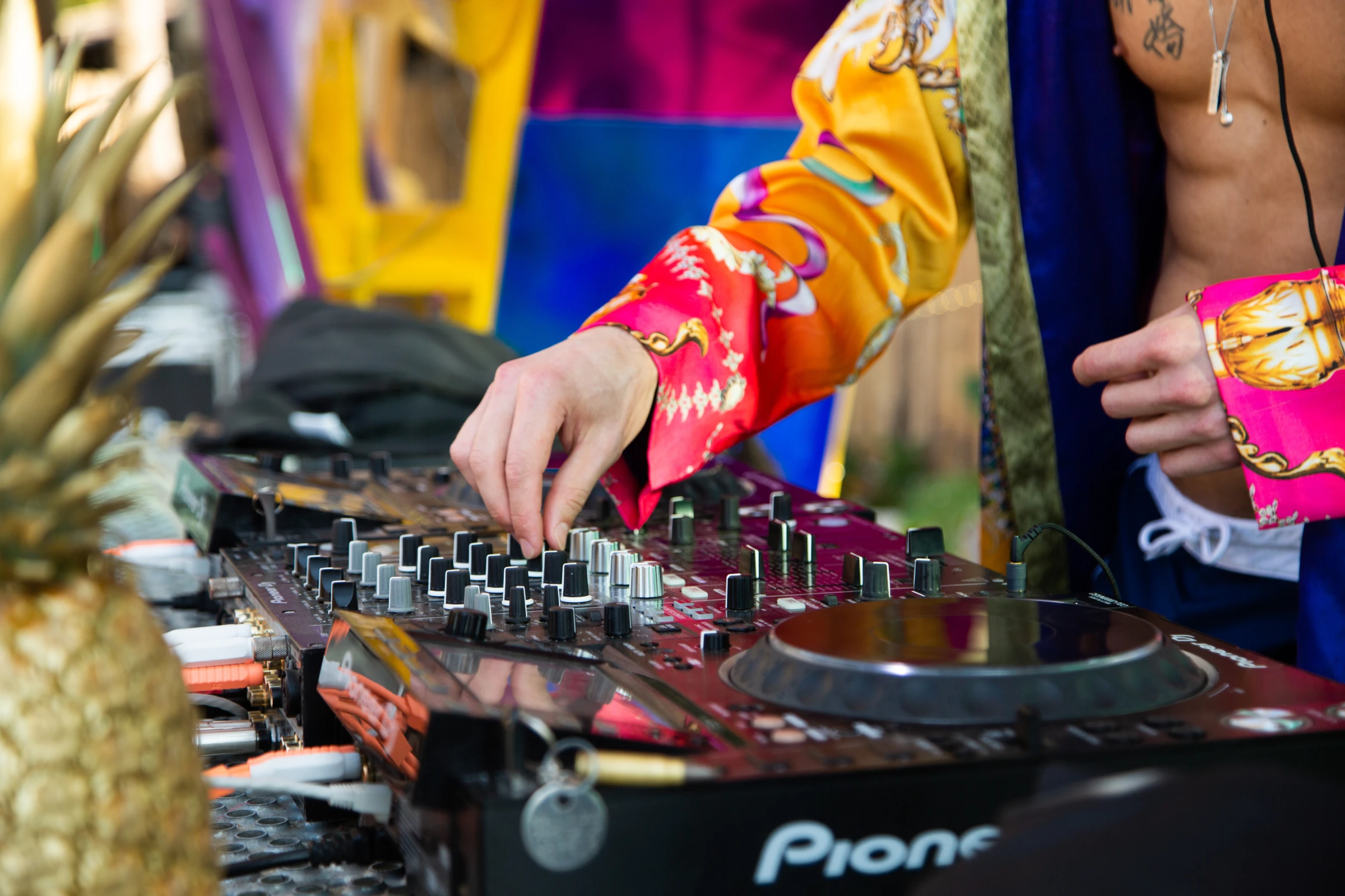 Manos ajustando una mezcladora de DJ
